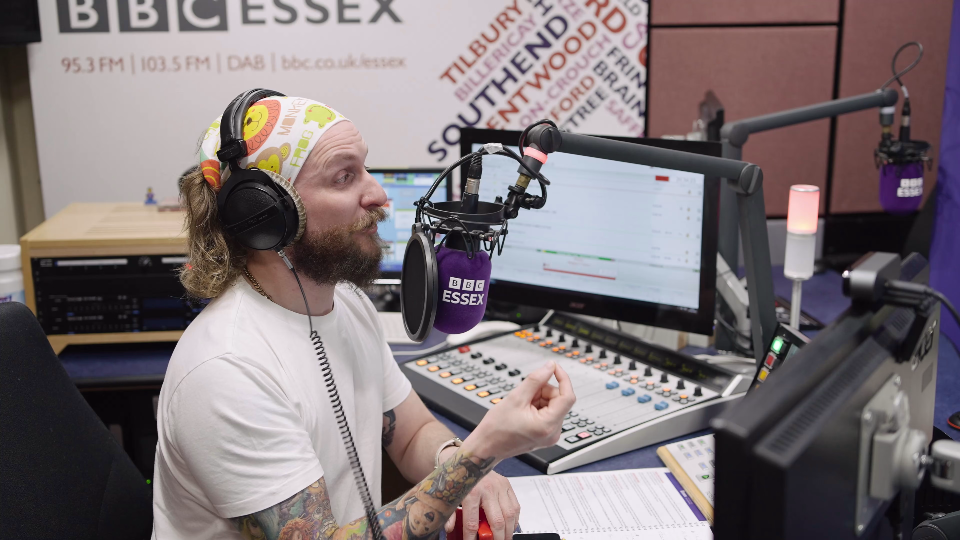 Radio presenter at the studio desk